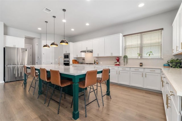 8600 Chrysler Bnd, Austin, TX 78744 - kitchen with visible vents, recessed lighting, appliances with stainless steel finishes, and backsplash