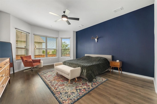 8600 Chrysler Bnd, Austin, TX 78744 - bedroom featuring a ceiling fan, baseboards, visible vents, and dark wood finished floors
