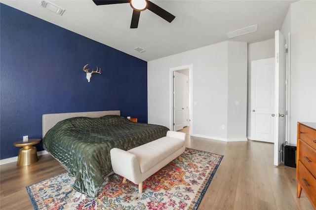 8600 Chrysler Bnd, Austin, TX 78744 - bedroom with visible vents, baseboards, and wood finished floors
