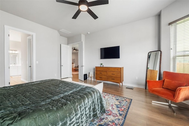 8600 Chrysler Bnd, Austin, TX 78744 - bedroom featuring multiple windows, ensuite bathroom, wood finished floors, and visible vents