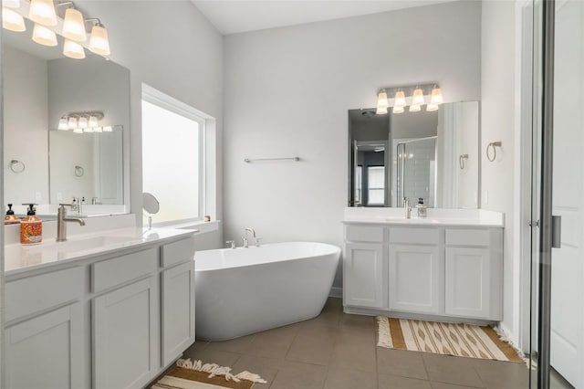 8600 Chrysler Bnd, Austin, TX 78744 - bathroom with a sink, tile patterned flooring, a stall shower, and a freestanding bath