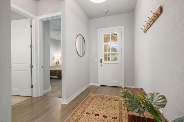 8600 Chrysler Bnd, Austin, TX 78744 - entryway featuring baseboards, wood finished floors, and visible vents