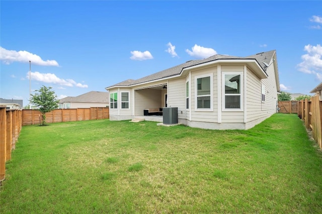 8600 Chrysler Bnd, Austin, TX 78744 - back of property with a lawn, a fenced backyard, and central AC