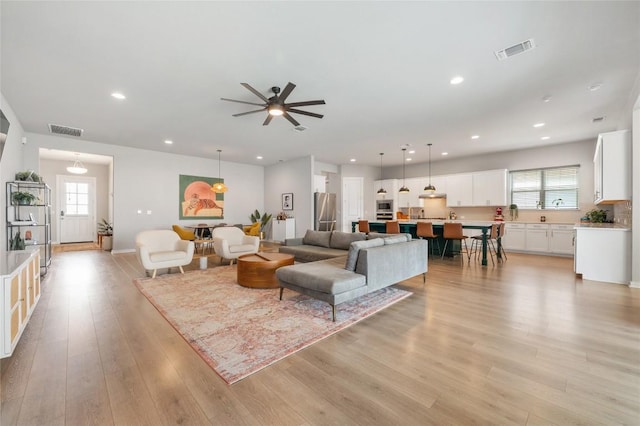 8600 Chrysler Bnd, Austin, TX 78744 - living area with visible vents, plenty of natural light, and light wood-style floors