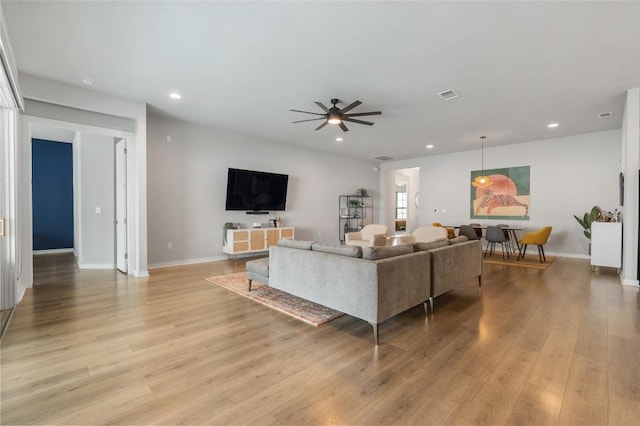 8600 Chrysler Bnd, Austin, TX 78744 - living area with baseboards, a ceiling fan, light wood-type flooring, and visible vents
