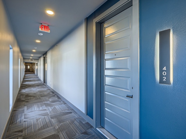 hallway featuring baseboards and recessed lighting