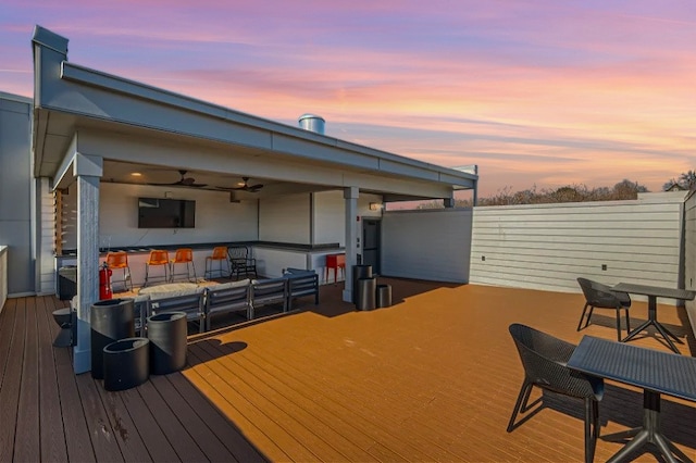 wooden deck featuring a ceiling fan and outdoor dry bar