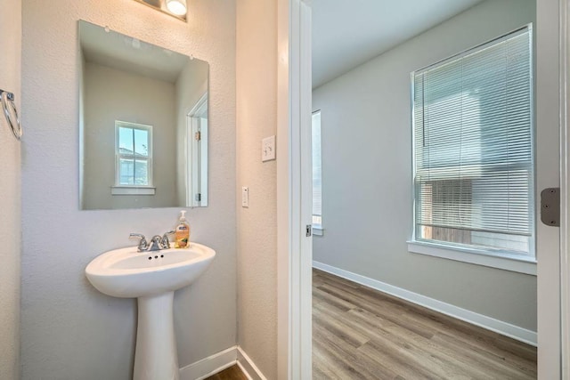bathroom featuring baseboards and wood finished floors