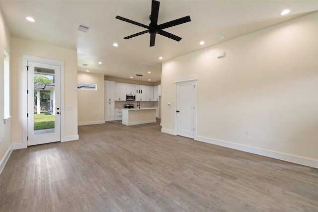 1000 Vargas Rd Unit A, Austin, TX 78741 - unfurnished living room featuring recessed lighting, ceiling fan, and light wood-type flooring
