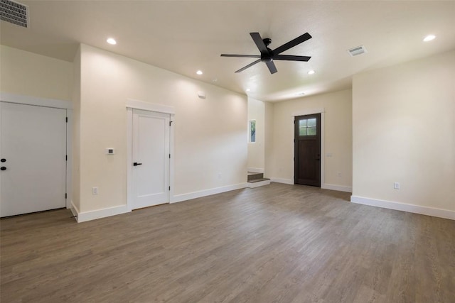 unfurnished living room featuring a ceiling fan, wood finished floors, and visible vents