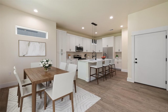 1000 Vargas Rd Unit A, Austin, TX 78741 - dining area with light wood-style flooring and recessed lighting