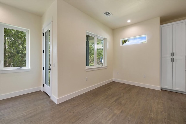 entrance foyer featuring baseboards, dark wood finished floors, and visible vents