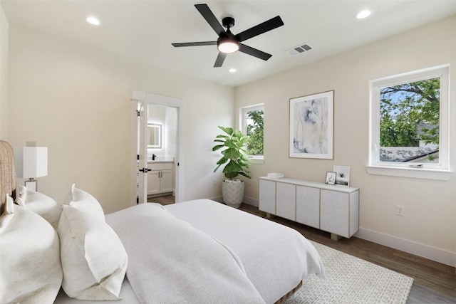 bedroom with visible vents, recessed lighting, baseboards, and wood finished floors