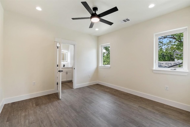 1000 Vargas Rd Unit A, Austin, TX 78741 - unfurnished bedroom featuring recessed lighting, wood finished floors, and connected bathroom