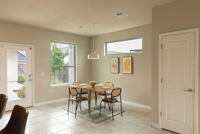 dining area with baseboards and visible vents