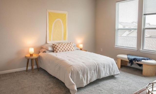 bedroom with carpet flooring, baseboards, and multiple windows
