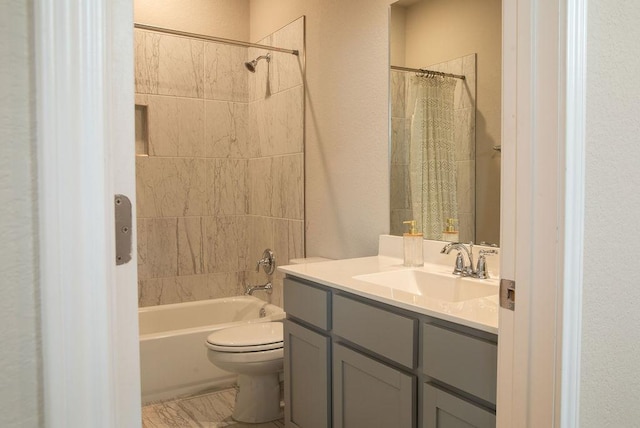 bathroom featuring vanity, a textured wall, shower / bath combo, and toilet