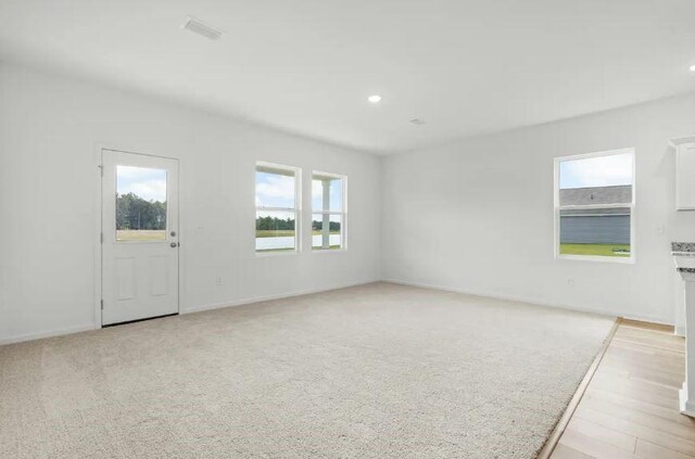 interior space with baseboards, recessed lighting, and a wealth of natural light