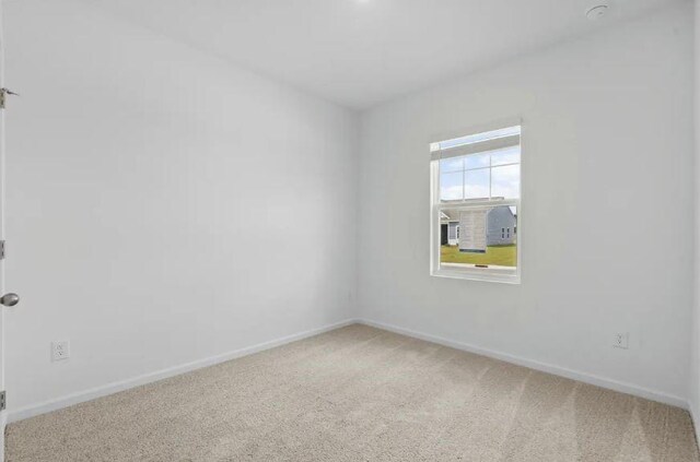 empty room with carpet floors and baseboards
