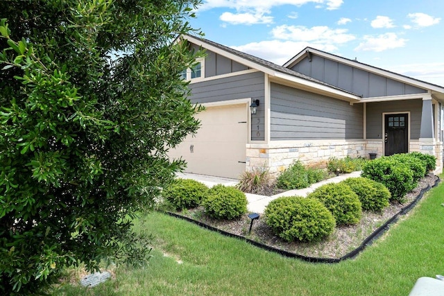 316 Ancellotta Way, Leander, TX 78641 - view of side of home featuring board and batten siding, stone siding, and a yard