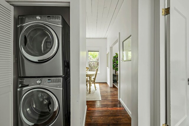 1613 Garden St, Austin, TX 78702 - laundry area featuring stacked washer and clothes dryer, dark wood-type flooring, and wooden ceiling