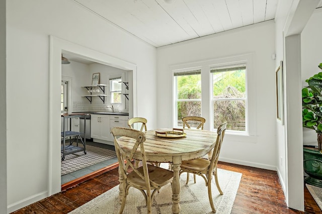 dining space with baseboards, wooden ceiling, and hardwood / wood-style flooring