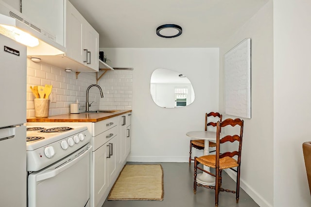 1613 Garden St, Austin, TX 78702 - kitchen with white appliances, ventilation hood, backsplash, and white cabinets