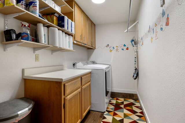 clothes washing area featuring cabinet space, independent washer and dryer, and baseboards