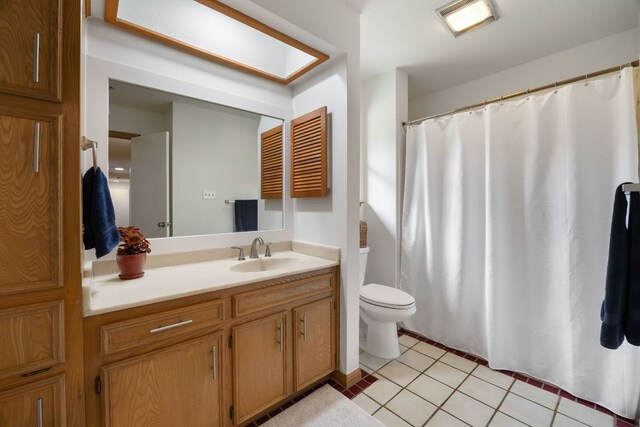 full bathroom with tile patterned flooring, toilet, and vanity