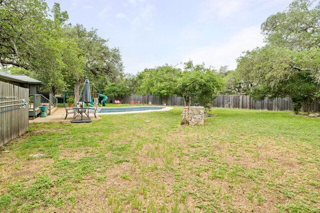view of yard with a fenced in pool and a fenced backyard