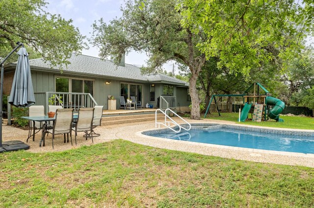 view of swimming pool with a fenced in pool, a playground, a yard, and outdoor dining space