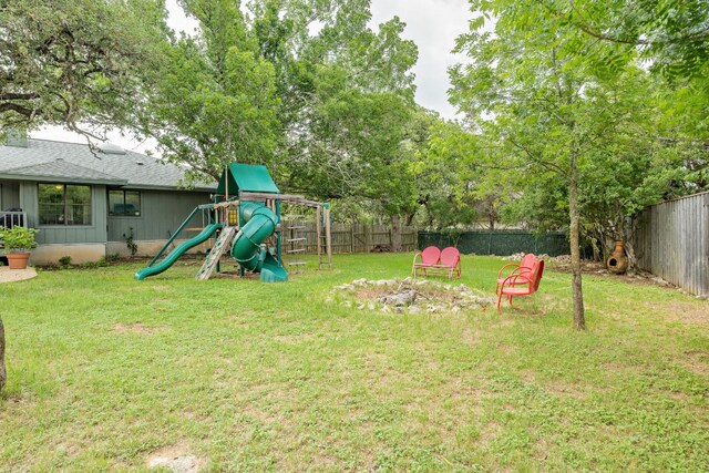 view of yard featuring a playground and a fenced backyard