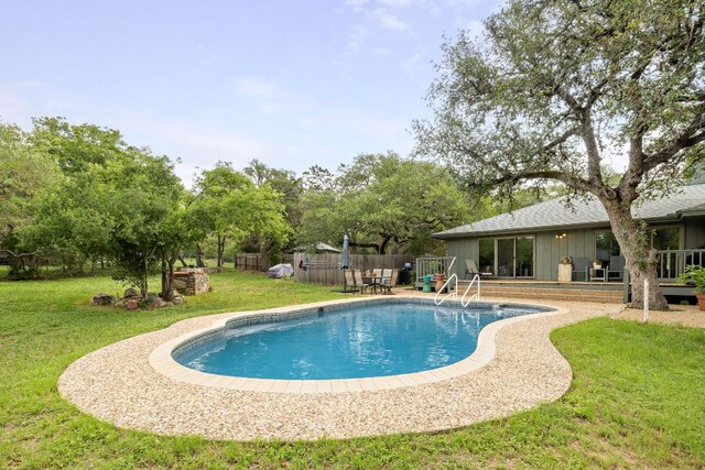 view of pool featuring a fenced in pool, a lawn, and fence