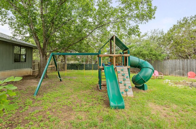 view of play area featuring a fenced backyard and a yard
