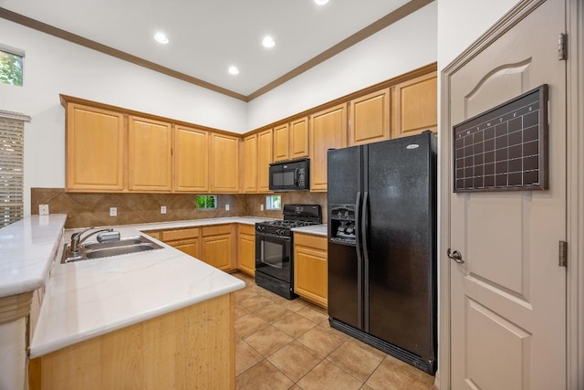 kitchen with a sink, light countertops, a peninsula, backsplash, and black appliances
