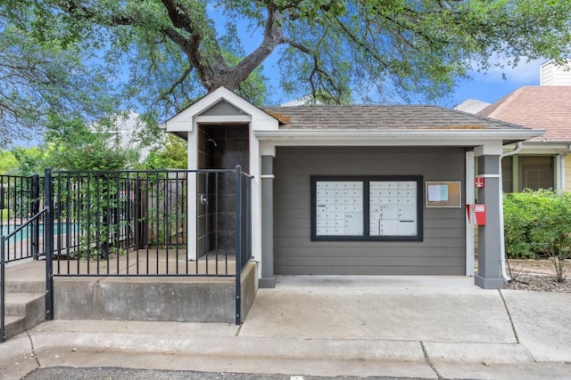 ranch-style home with fence and a shingled roof
