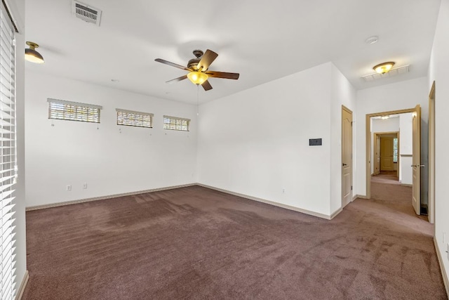 spare room featuring baseboards, a ceiling fan, carpet flooring, and visible vents