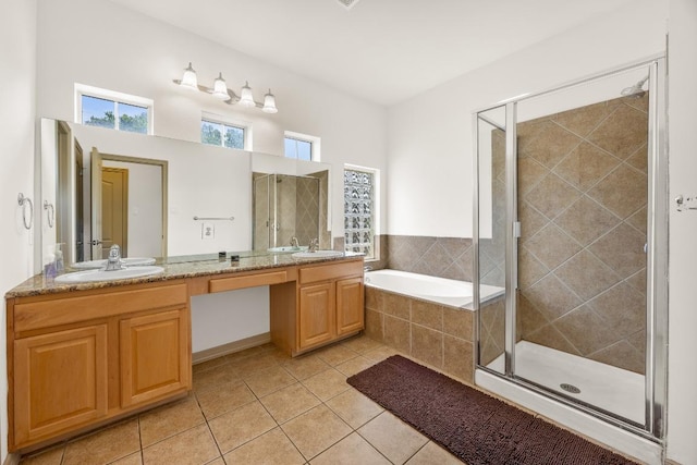 full bathroom featuring tile patterned floors, a sink, and a stall shower