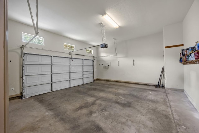 6704 Menchaca Rd Unit 43, Austin, TX 78745 - garage featuring baseboards and a garage door opener