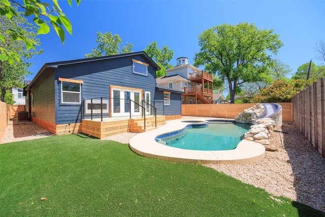 1007 Payne Ave, Austin, TX 78757 - view of swimming pool with french doors, a fenced in pool, a yard, and a fenced backyard