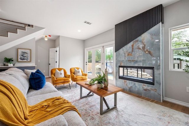 1007 Payne Ave, Austin, TX 78757 - living area with visible vents, wood finished floors, a wealth of natural light, and a fireplace
