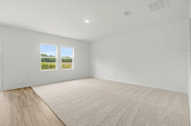1441 Morris Loop, San Marcos, TX 78666 - spare room featuring recessed lighting, baseboards, and light wood-style floors
