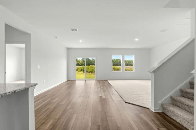 1441 Morris Loop, San Marcos, TX 78666 - unfurnished living room with wood finished floors, recessed lighting, stairs, and baseboards