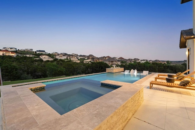 pool featuring a patio and an in ground hot tub