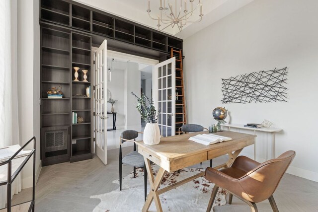 office area with an inviting chandelier, baseboards, and french doors