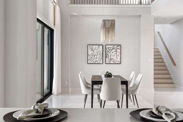 dining area featuring stairway and baseboards