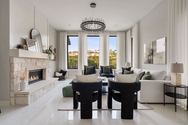 dining space with a stone fireplace, tile patterned flooring, and a chandelier