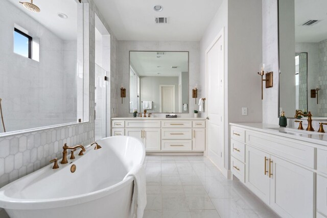 full bath with visible vents, a stall shower, vanity, marble finish floor, and a soaking tub