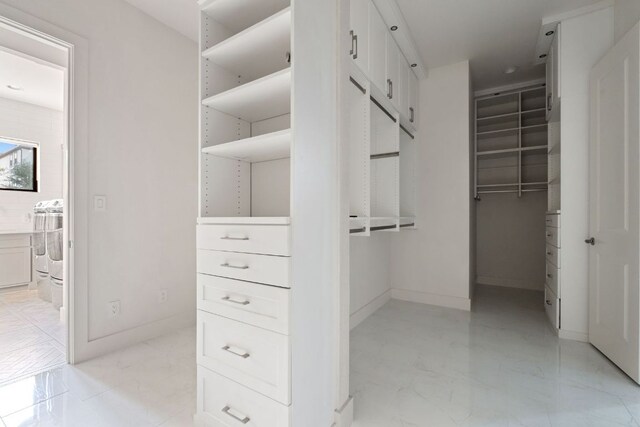 spacious closet featuring marble finish floor