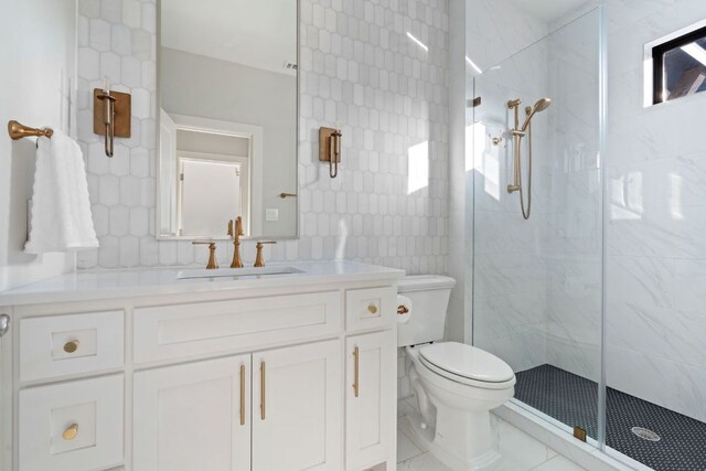 bathroom featuring vanity, a stall shower, and toilet